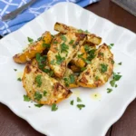 Air Fryer Patty Pan Squash with golden Parmesan edges on a white plate
