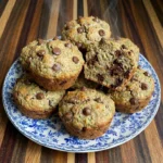 Chocolate Chip Zucchini Muffins with golden tops and melted chocolate chips