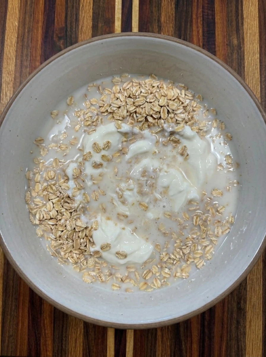 Oat base stirred with milk and yogurt for Peach Overnight Oats