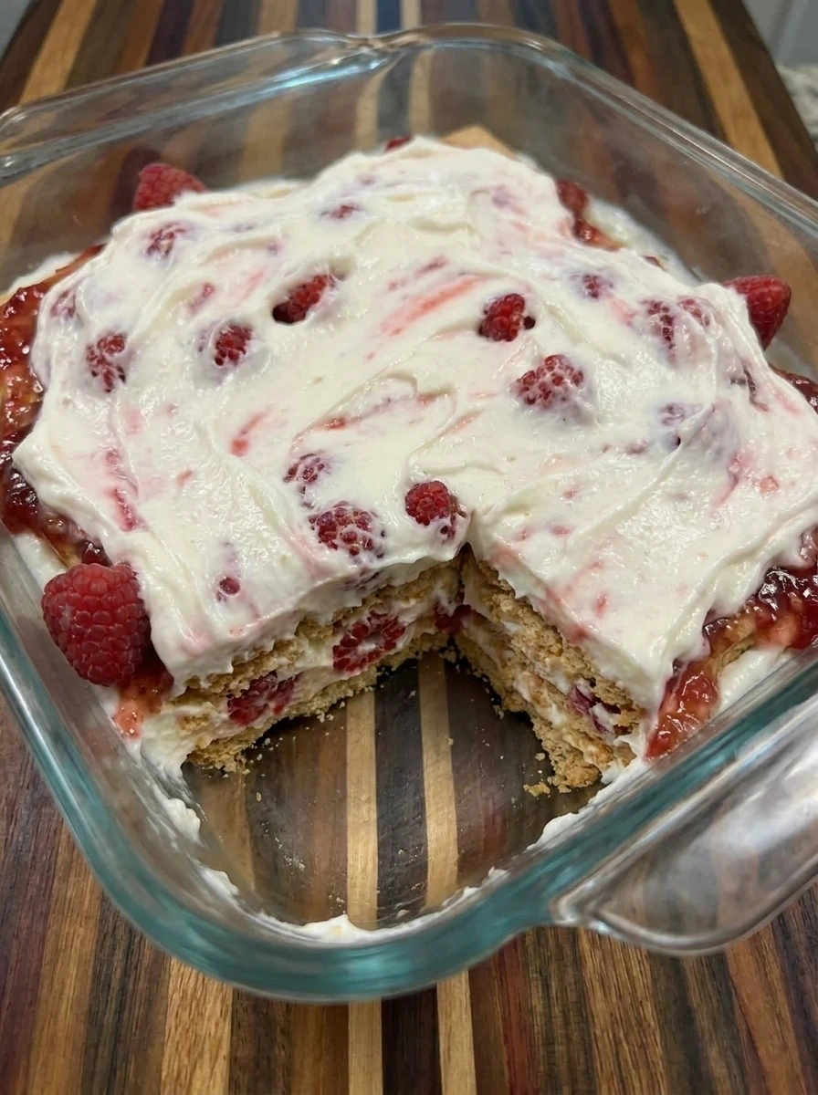 Chilled layered Raspberry Icebox Cake in glass dish