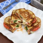 Tomato Mozzarella Sandwich with toasted bread melted cheese tomatoes and basil
