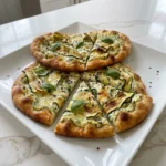 Zucchini and Herbed Ricotta Flatbread with crisp edges and creamy ricotta