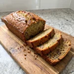 Moist homemade Zucchini Bread loaf with sliced pieces and visible zucchini flecks