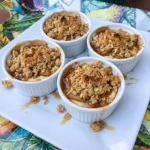 Apple Crisp Cheesecake Cups with golden oat topping and cinnamon apples