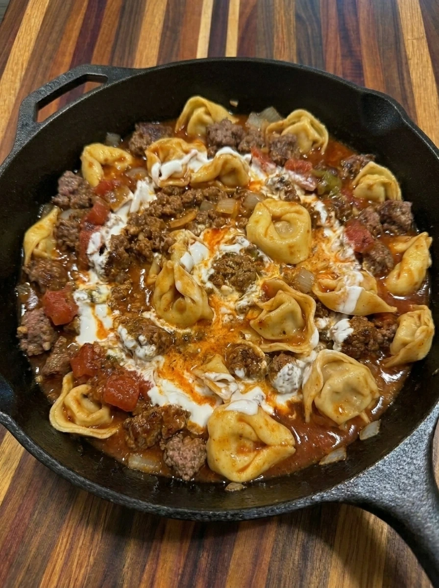 Tortellini folded into enchilada beef sauce with sour cream
