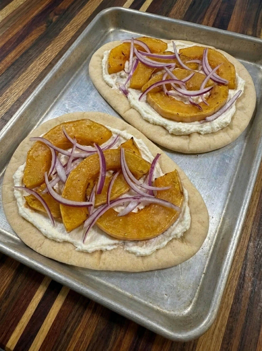 Roasted squash and red onion layered on flatbread