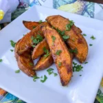 Cinnamon Sweet Potato Wedges with caramelized edges on a white plate