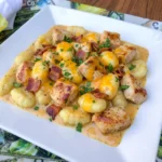 Creamy Crack Chicken Gnocchi served with bacon and melted cheddar sauce