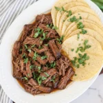 Tender Crockpot Barbacoa Beef with smoky sauce and warm corn tortillas