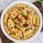 Creamy CrockPot Cheddar Bacon Chicken Rigatoni with melted cheese and bacon