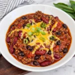 Crockpot Chili with beef beans cheddar and green onions