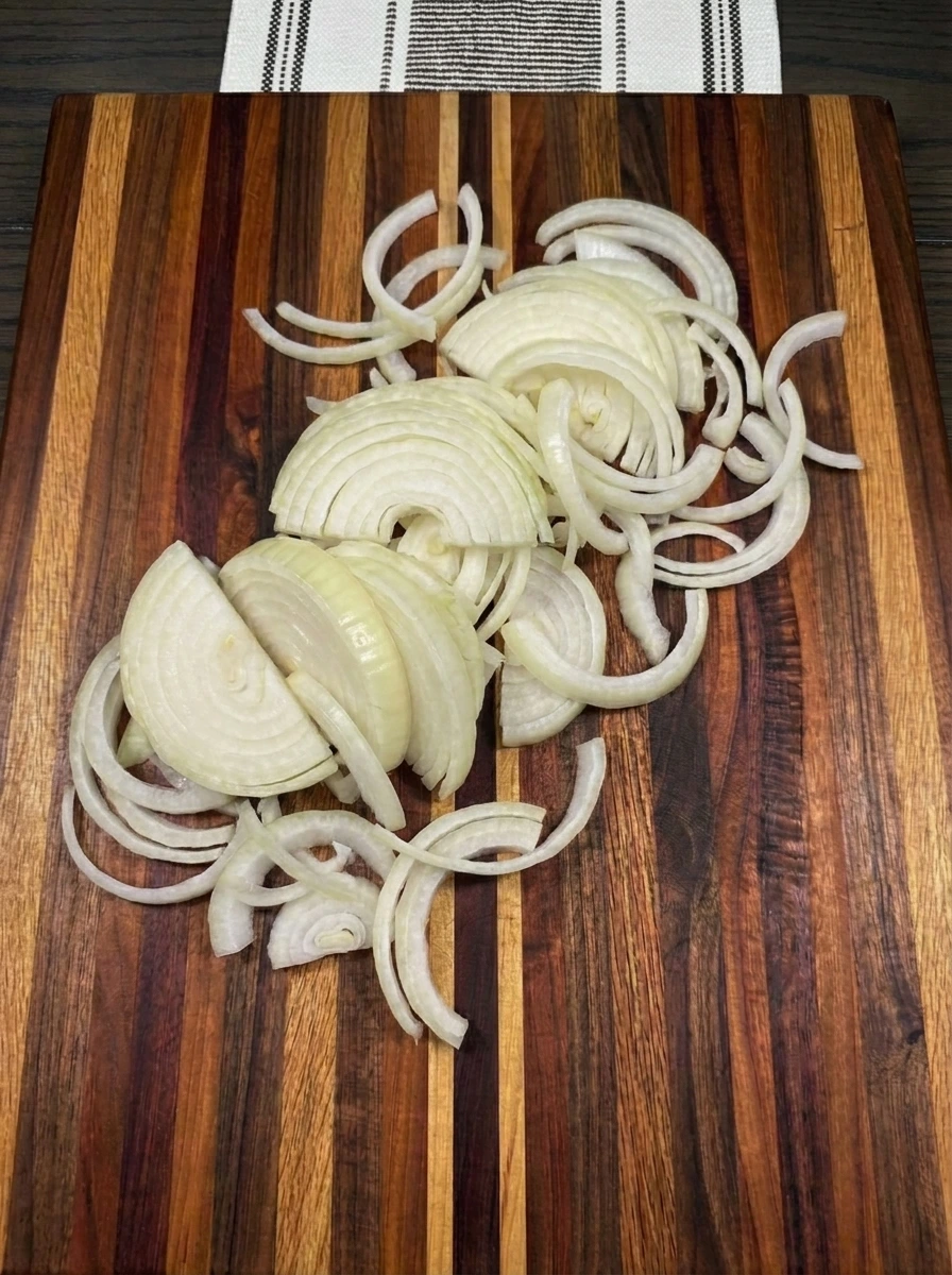 Four onions sliced into thin ribbons for Crockpot French Onion Soup