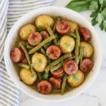 CrockPot Swamp Potatoes with sausage and green beans in buttery seasoned broth