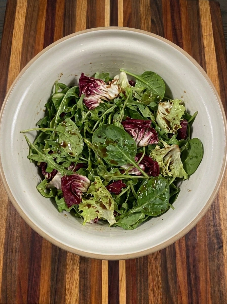 Mixed greens lightly coated with balsamic dressing