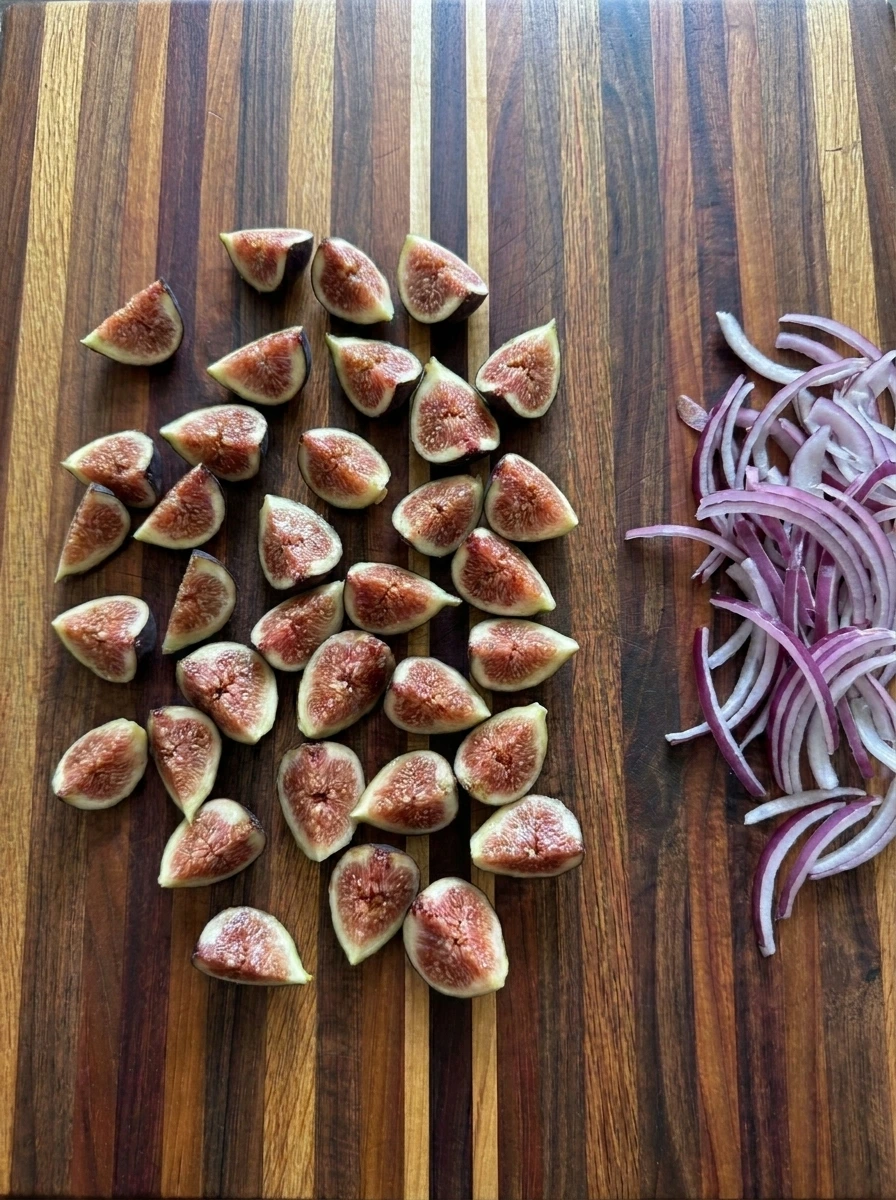 Fresh figs quartered beside thin red onion slices