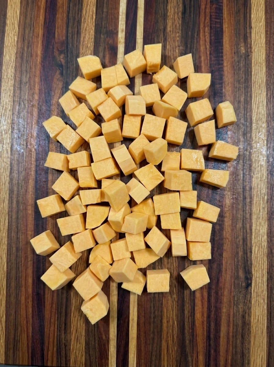 Fresh butternut squash cut into irregular cubes