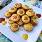 Golden Mini Corn Dog Muffins with visible hot dog centers and dipping sauces
