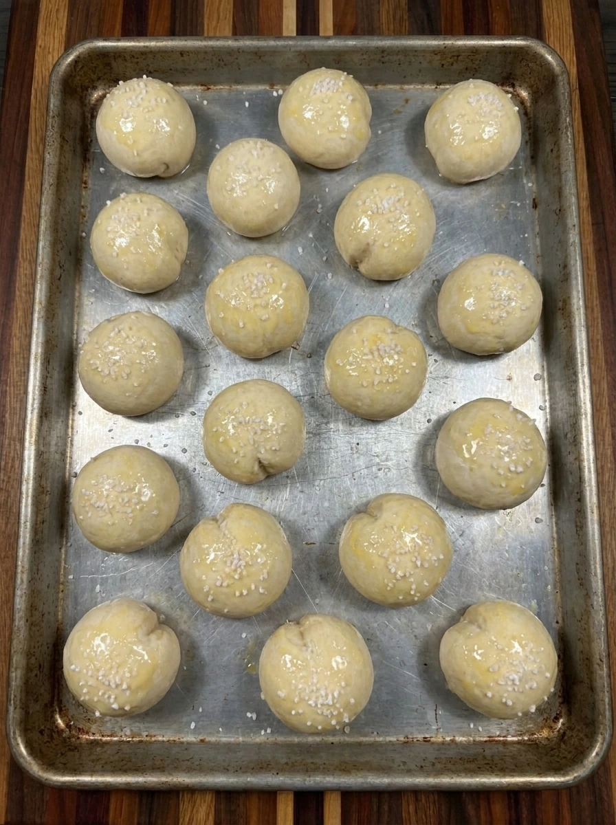 Sixteen stuffed pretzel bites brushed with egg and sprinkled with salt