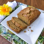 Moist Patty Pan Squash Bread with cinnamon and walnuts sliced on a white plate