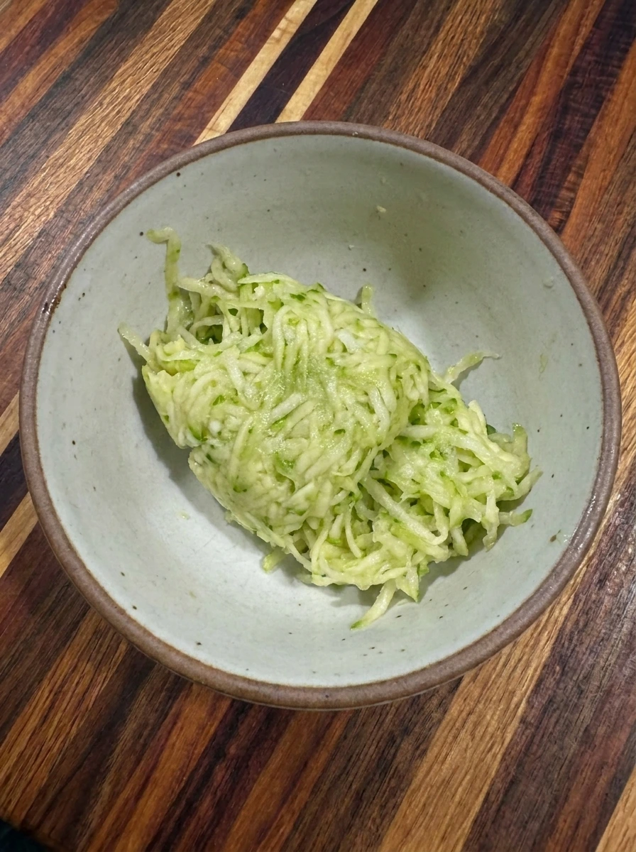 Finely grated patty pan squash squeezed for quick bread batter
