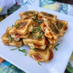 Golden Pizza Grilled Cheese Bites with melted mozzarella and pepperoni filling