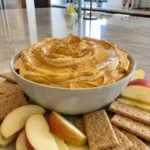 Creamy Pumpkin Cheesecake Dip with apple slices and graham crackers