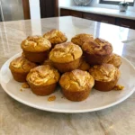Pumpkin Cream Cheese Muffins with creamy swirls and golden muffin tops