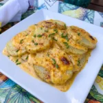 Slow Cooker Cheesy Scalloped Potatoes with melted cheddar and browned edges