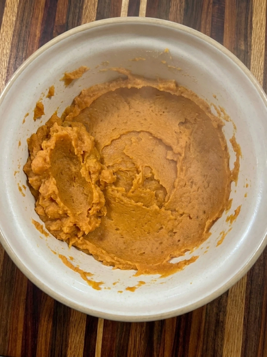 Warm mashed sweet potato prepared for gnocchi dough