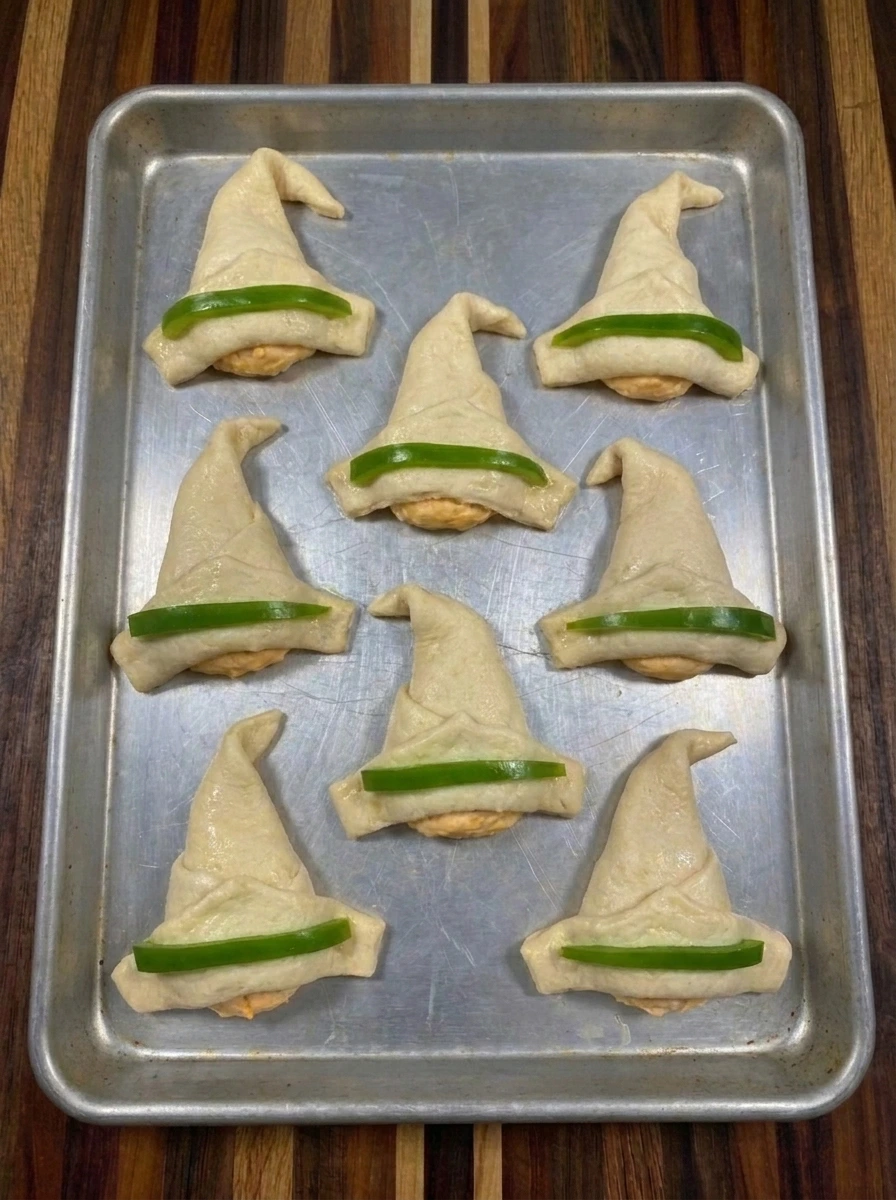 Green pepper strips added to eight Crescent Roll Witch Hats