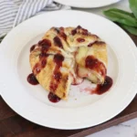 Halloween Bloody Baked Brie with golden puff pastry and raspberry blood drips
