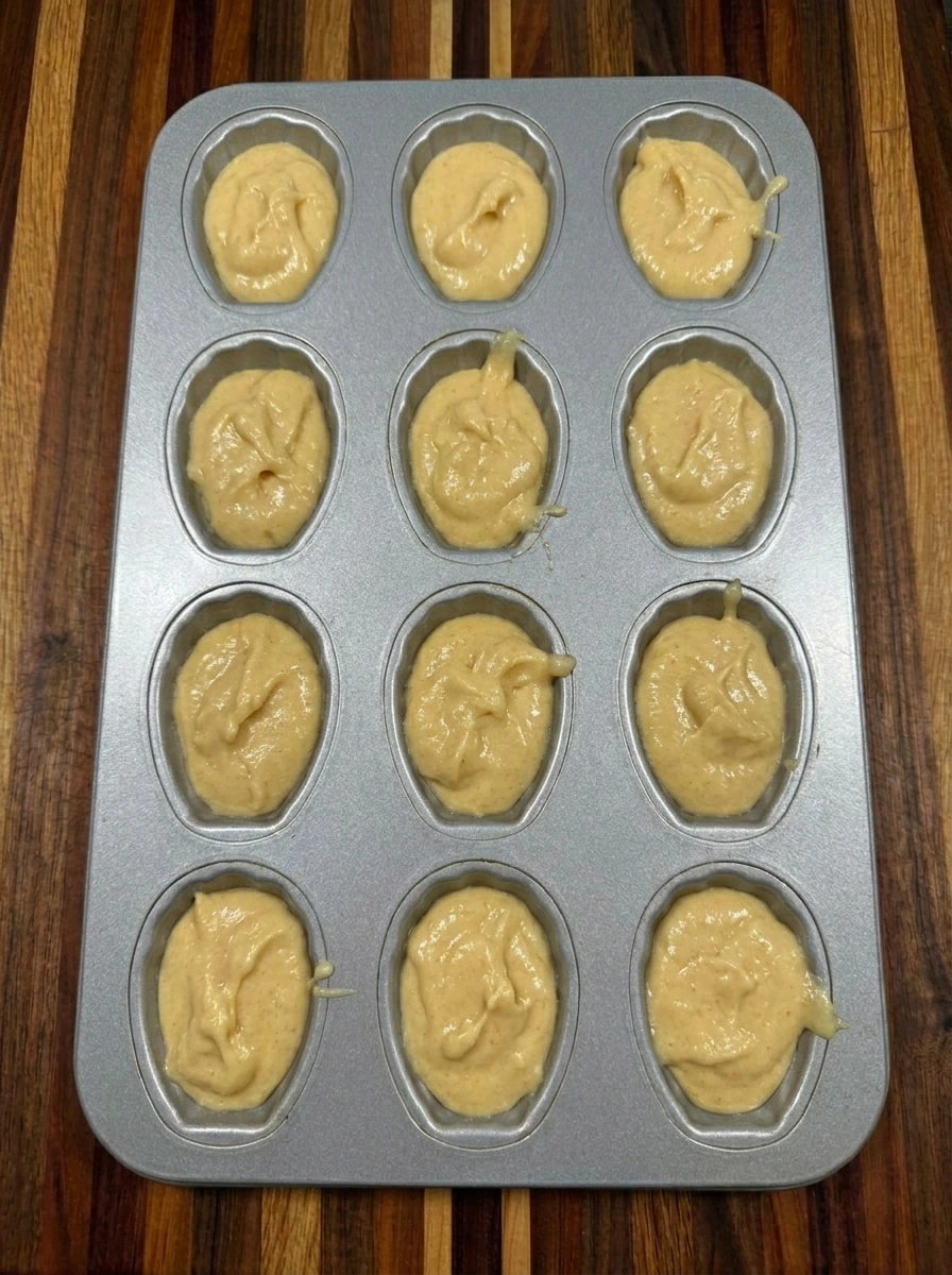 Chilled Halloween Ghost Madeleine batter divided among twelve shell shaped cavities