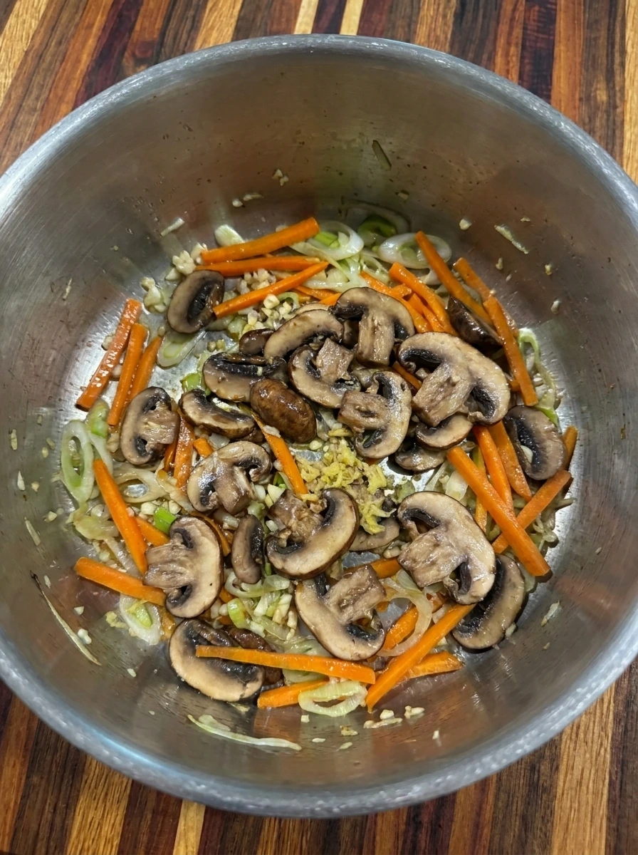 Softened mushrooms and aromatics for Potsticker Soup