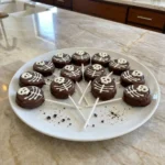 Finished Skeleton Cookie Pops with dark chocolate coating and white candy skeleton details