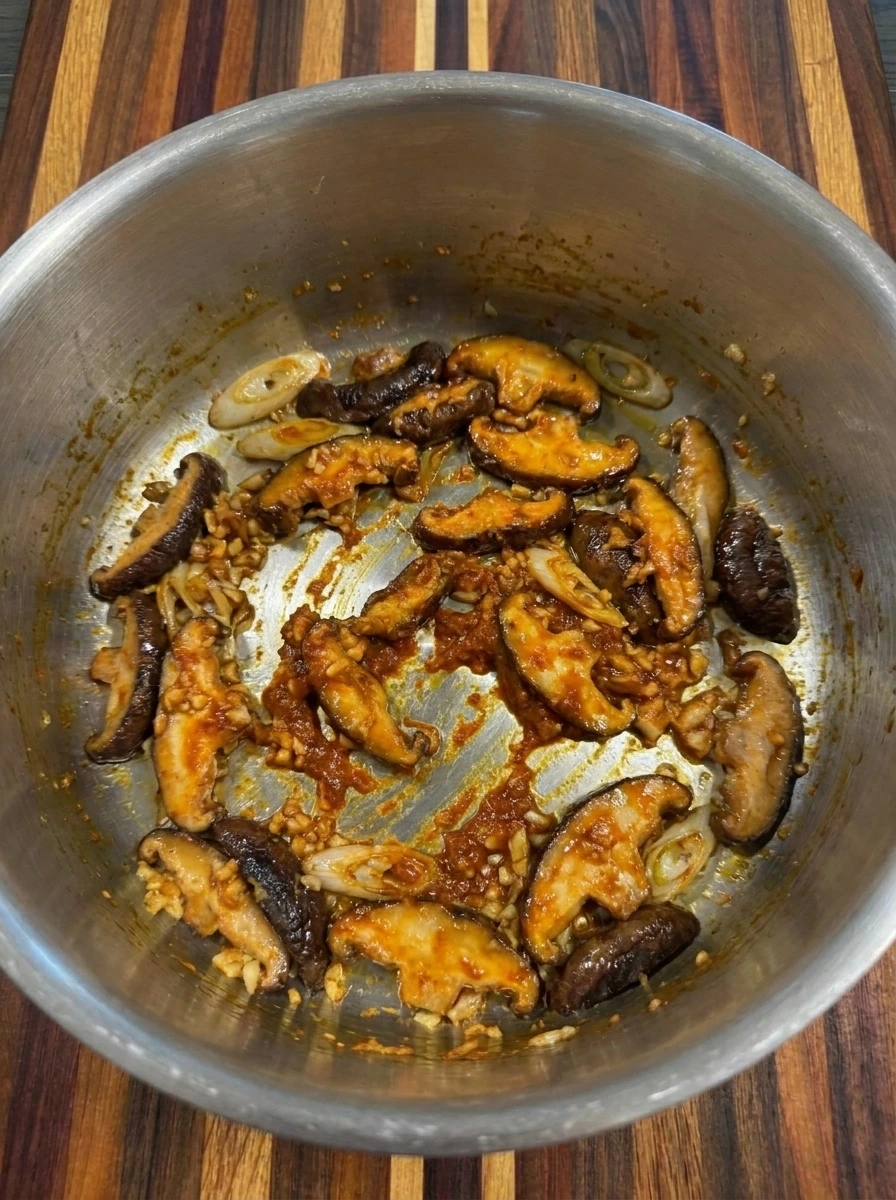 Mushrooms coated with red curry paste for Creamy Thai Dumpling Soup