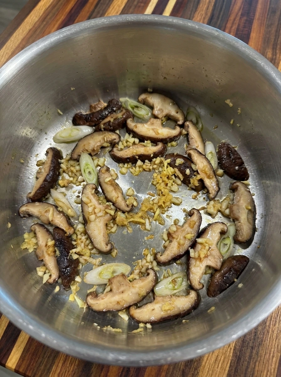 Softened mushrooms garlic and ginger for Creamy Thai Dumpling Soup