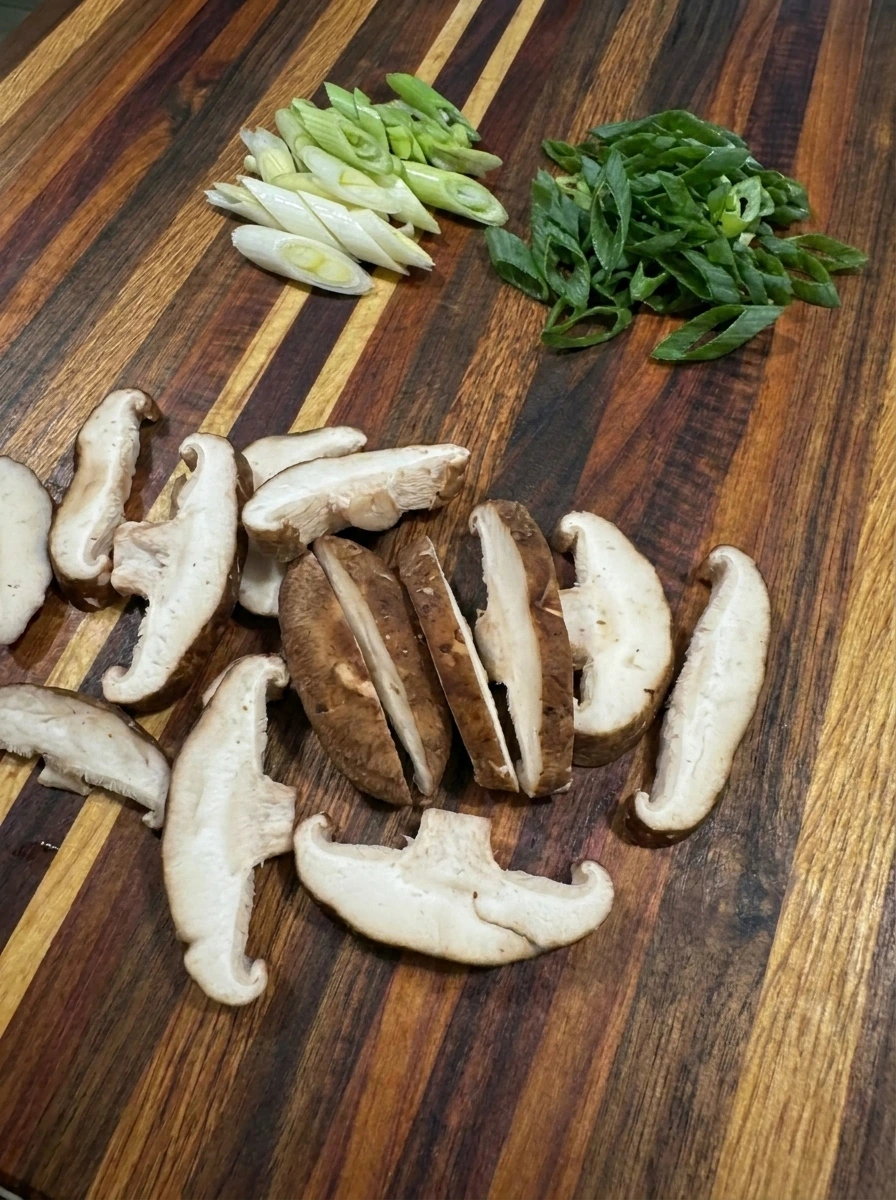 Sliced shiitake mushrooms and scallions for Creamy Thai Dumpling Soup