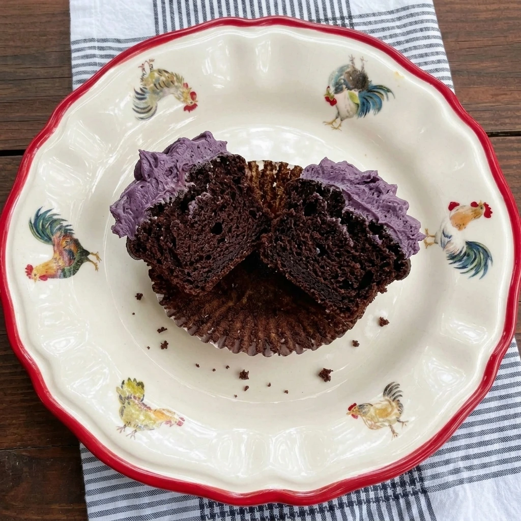 One Sleeping Draught Cupcake cut open to show the chocolate crumb