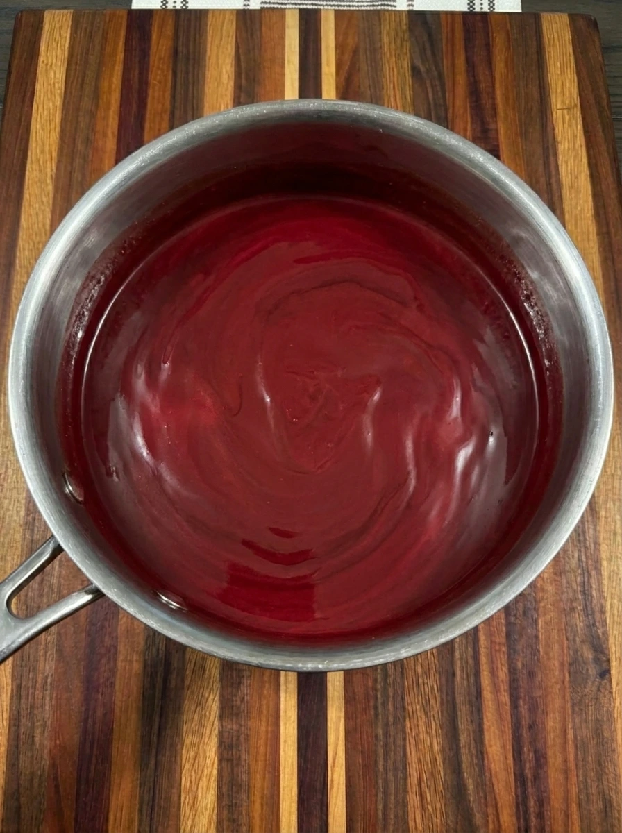 Deep red melted Vampire Hot Chocolate in a saucepan