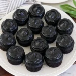 Black Velvet Cupcakes with dark cocoa frosting arranged on a serving plate