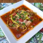 Homemade Cabbage Roll Soup with tender cabbage and ground beef and rice in a rich tomato broth topped with fresh parsley