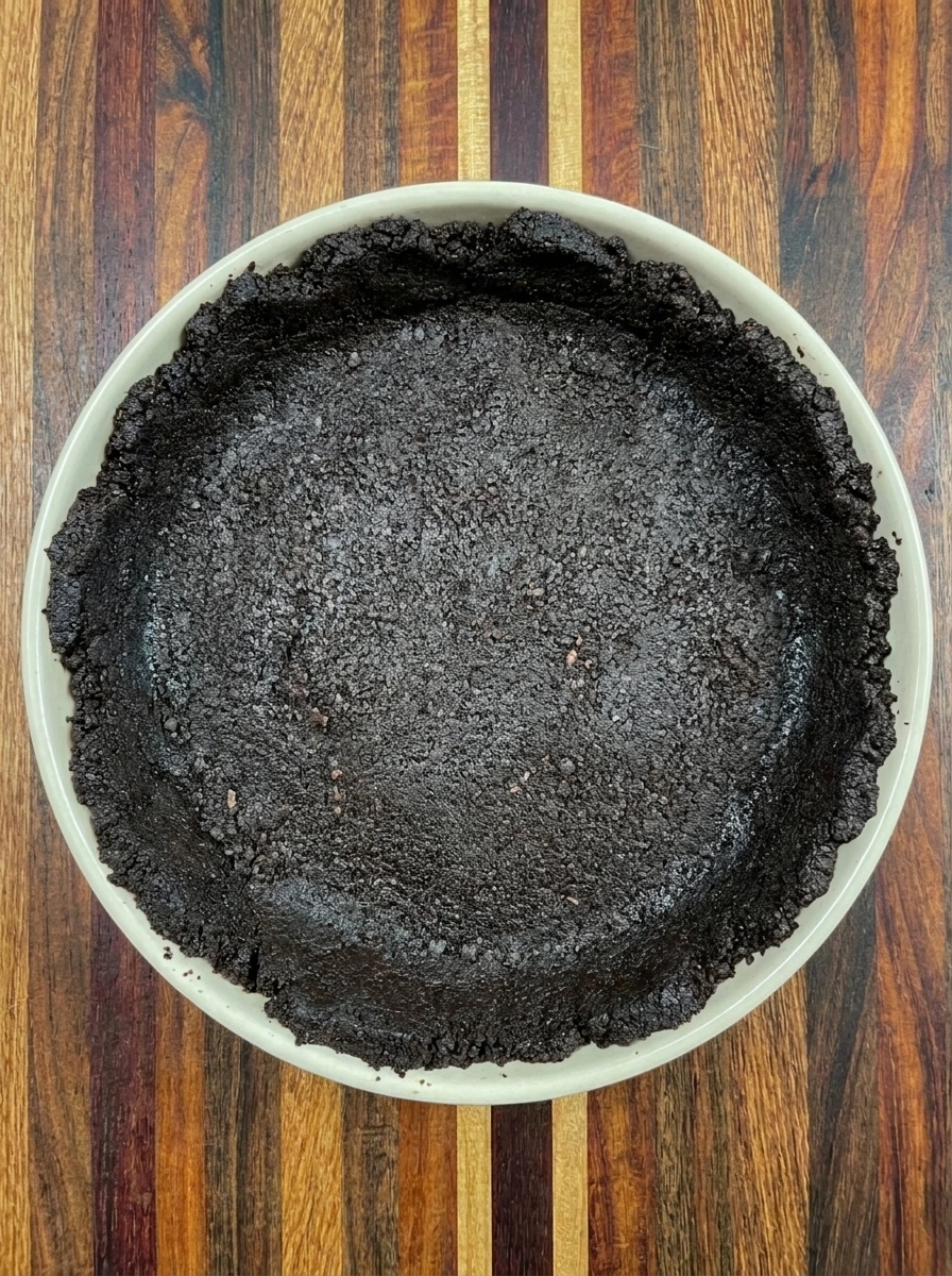 Chocolate crumb crust pressed into tart dish