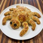 Golden Halloween Spider Bread with eight bread legs and olive eyes