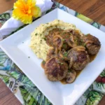 Salisbury Steak Meatballs with Garlic Herb Mashed Potatoes covered with mushroom onion gravy