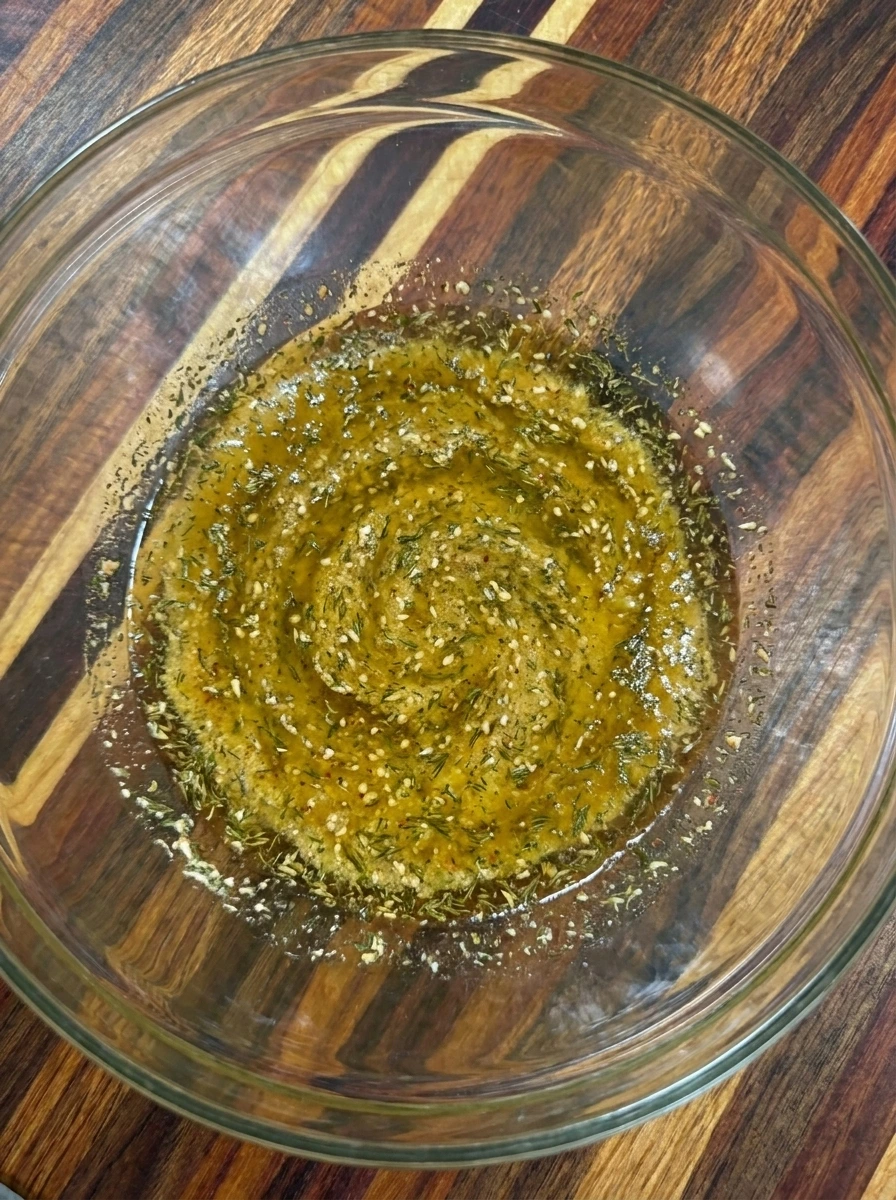 Ranch seasoning and herbs mixed into oil for Seasoned Pretzels