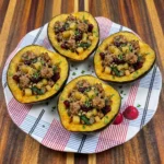 Turkey-Stuffed Acorn Squash filled with savory ground turkey vegetables cranberries and pecans